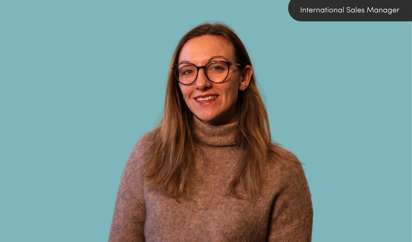 Becky Plummer smiling against blue background
