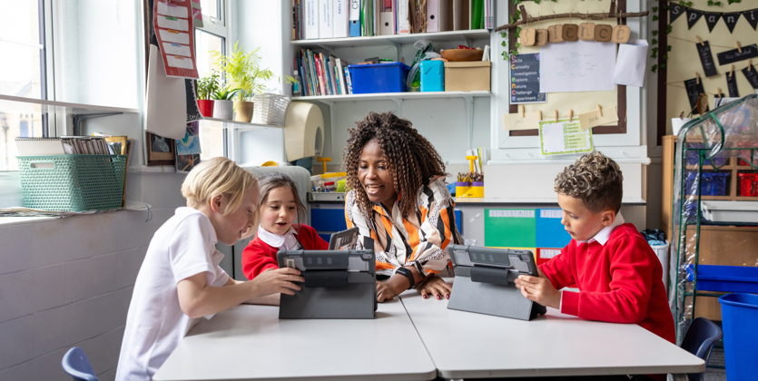 Primary aged children learning in a classroom with their teacher