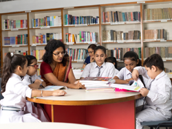teacher with students in library