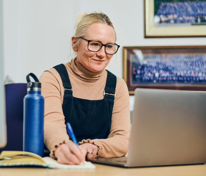 teacher taking notes