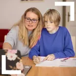 Parent helping teenage child to study