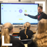 teacher pointing at screen